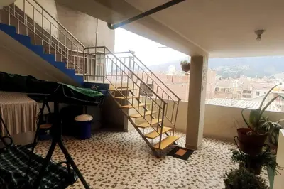 a spiral staircase in a room with a large window at Depawanka 2 in Huancayo