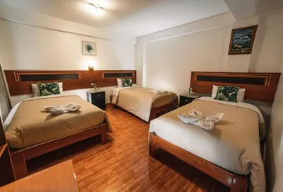 a hotel room with two beds with bows at Escobedo’s Inn Machupicchu in Machu Picchu