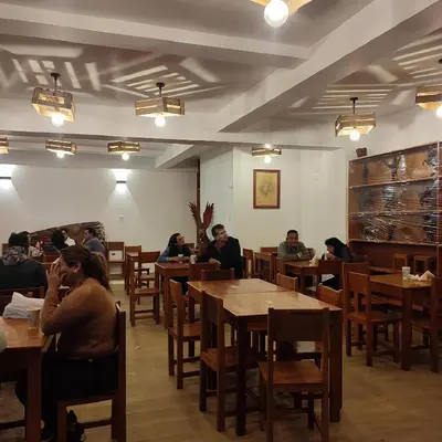 a group of people sitting at tables in a restaurant at Hospedaje Hamuy's Lodge in Ica