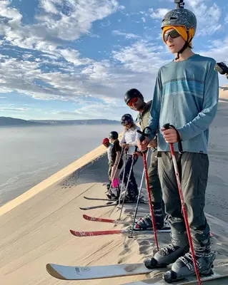 a group of people on skis in the desert at Acari Adventure & ski Resort in Acarí