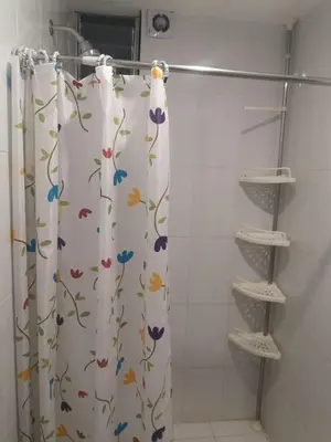 a shower curtain with flowers on it in a bathroom at Encanta Perú Apartment in Cusco