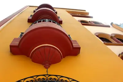 a building with two red fans on the side of it at Pretty House Hotel in Lima