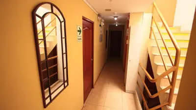 a hallway with a mirror and stairs in a building at Pretty House Hotel in Lima