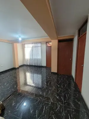 an empty room with a marble floor and a window at Apartamento en Huancayo in Huancayo