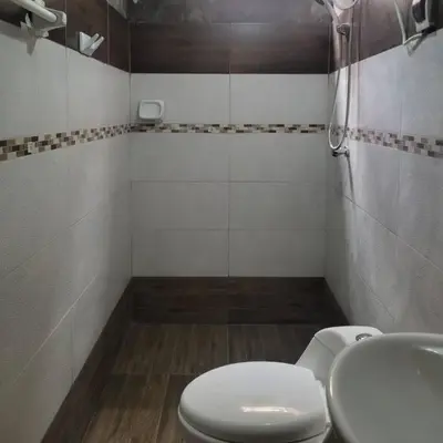 a bathroom with a white toilet and a sink at Apartamento en Huancayo in Huancayo