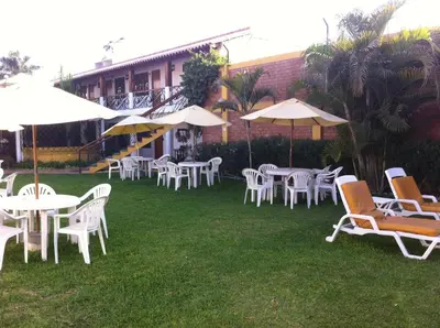 a group of tables and chairs with umbrellas at Oro Viejo in Nazca
