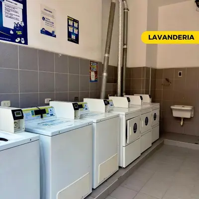 a row of washers and dryers in a laundry room at Bonito departamento VIP estreno en Condominio in Lima
