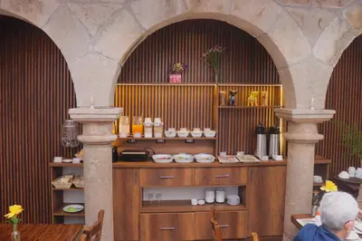 a room with two arches and a counter with food at Cusco Lodge Hotel Boutique in Cusco