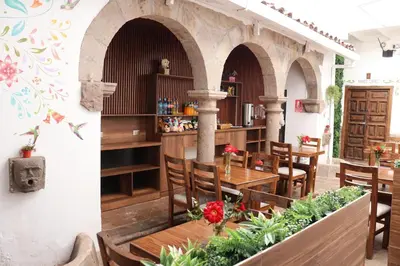 two photos of a restaurant with tables and chairs at Cusco Lodge Hotel Boutique in Cusco