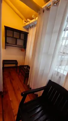 a living room with a couch and a window at Cusco Lodge Hotel Boutique in Cusco