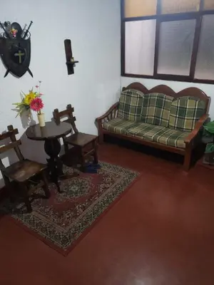 a living room with a couch and a table and chairs at Hospedaje Miraflores 17 in Lima
