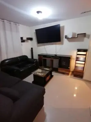 a living room with a couch and a flat screen tv at Mini departamento lujo in Lima