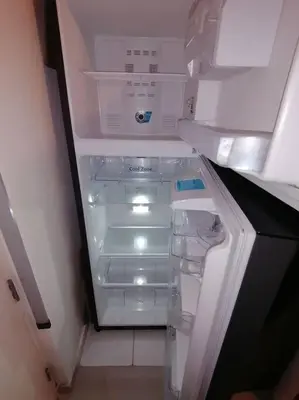 an empty refrigerator with its door open in a room at Mini departamento lujo in Lima
