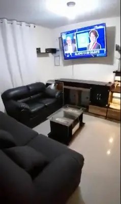 a living room with a couch and a flat screen tv at Mini departamento lujo in Lima