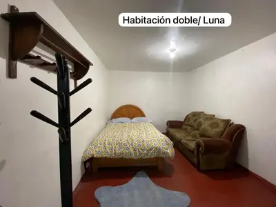 a living room with a bed and a couch at Casa Katya Cusco in Cusco