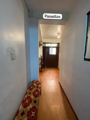 a room with a hallway with a bench and a door at Casa Katya Cusco in Cusco