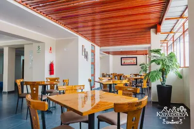 a dining room with wooden tables and chairs at Hotel Kapadokya in Huánuco
