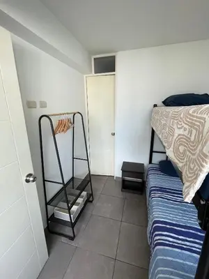a bedroom with a bed and a shelf next to a bed at Departamento 17 personas San Isidro in Lima