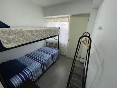 a small room with a bunk bed and a ladder at Departamento 17 personas San Isidro in Lima