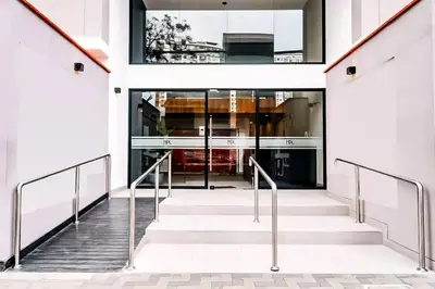 a staircase leading to a building with glass doors at Apartamento en Barranco in Lima