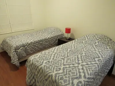 two beds sitting next to each other in a room at Spacious Apartment in Miraflores in Lima