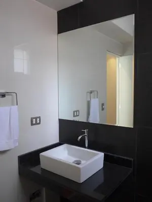 a bathroom with a white sink and a mirror at Spacious Apartment in Miraflores in Lima