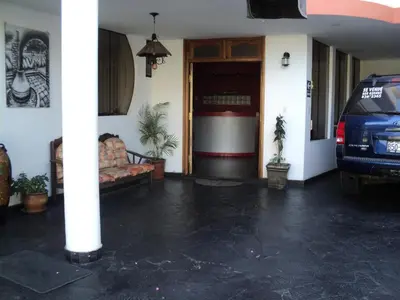 a living room with a car parked in front of a building at Hotel Conquistadores Inn in Ica