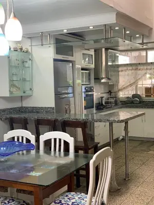a kitchen with a table and chairs and a counter at Apartamento Playa Arica in Lurín