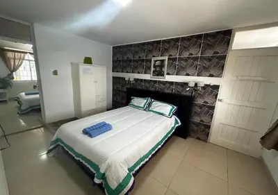 a bedroom with a large bed with a fireplace at Apartamento Playa Arica in Lurín