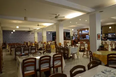a dining room with tables and chairs in a restaurant at Casablanca Hotel in San Ramón