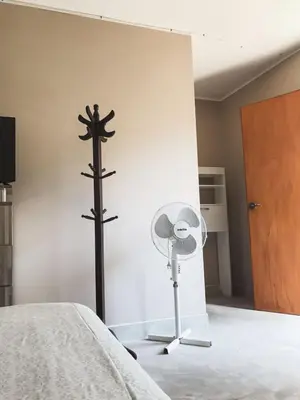 a room with a cross and a fan at Casa - Hospedaje Munay Ki - Yoga - in Pisco