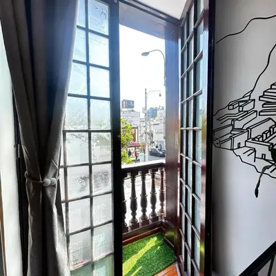 an open door to a balcony with a window at Hostel Prada in Lima