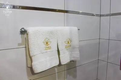 a towel hanging on a shower door in a bathroom at Terra Premium Hotel in Huánuco