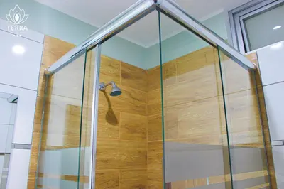 a shower with a glass door in a bathroom at Terra Premium Hotel in Huánuco