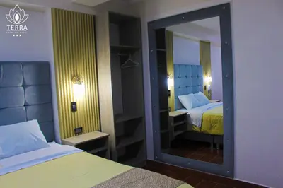 a mirror in a hotel room with two beds at Terra Premium Hotel in Huánuco