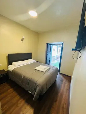a bedroom with a large bed in a room at Casa Virgen del Carmen in Cusco