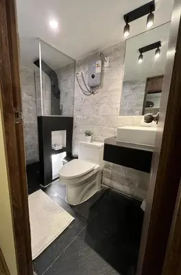 a bathroom with a white toilet and a sink at Casa Virgen del Carmen in Cusco