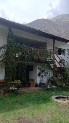 a house with ivy growing on the side of it at Casa Corazao in Urubamba