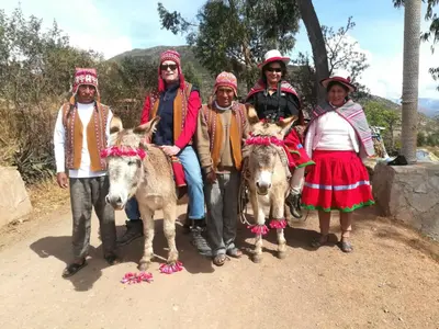 a group of people posing for a picture with donkeys at Casa Corazao in Urubamba