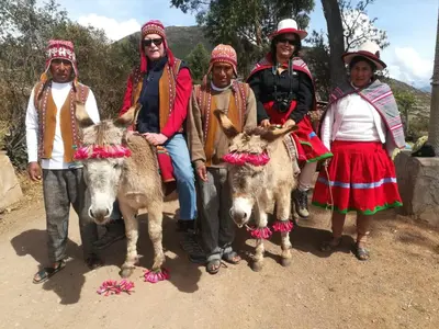 a group of people posing for a picture with donkeys at Casa Corazao in Urubamba