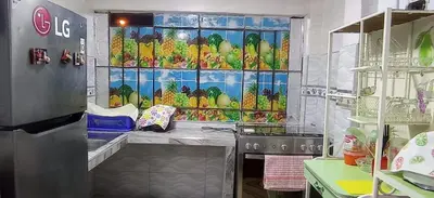 a kitchen with a window with a bunch of fruit at LA POSADA CHASQUI Perú in Lima