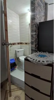 a small bathroom with a toilet and a sink at LA POSADA CHASQUI Perú in Lima