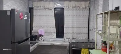 a kitchen with a large window with curtains at LA POSADA CHASQUI INN en LIMA in Lima