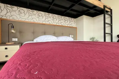 a large red bed with two pillows on it at Casa Dama in Cieneguilla