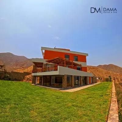 a large house on top of a grassy field at Casa Dama in Cieneguilla
