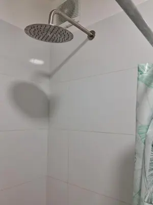 a shower with a shower head in a bathroom at Habitación Cama 2 plazas persona sola p pareja in Lima
