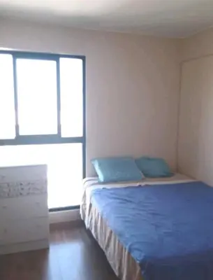 a bedroom with a bed with blue pillows on it at Habitación Cama 2 plazas persona sola p pareja in Lima