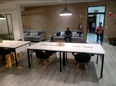 a room with two tables and chairs and people at Habitación Cama 2 plazas persona sola p pareja in Lima