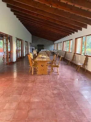 a large room with a table and chairs in it at FUNDO VIERA: Amplio y acogedor in Lima