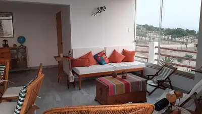 a living room with a white couch and a balcony at CASA DE PLAYA Durante todo el año in Punta Negra